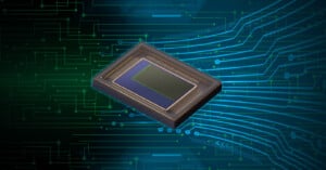A digital illustration of a rectangular computer chip with a central sensor, set against a background of abstract blue and green circuitry lines and patterns.