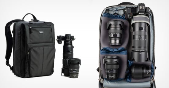 A black camera backpack is shown next to a camera and three lenses. The bag is open, revealing organized compartments with a camera body attached to a lens, plus three additional lenses.