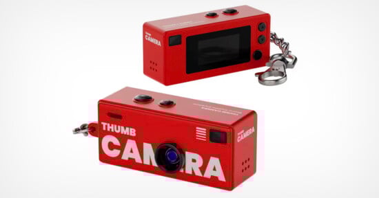 Two views of a small, red rectangular digital camera with "THUMB CAMERA" printed on it, featuring a lens, buttons, a screen, and a keychain attachment.