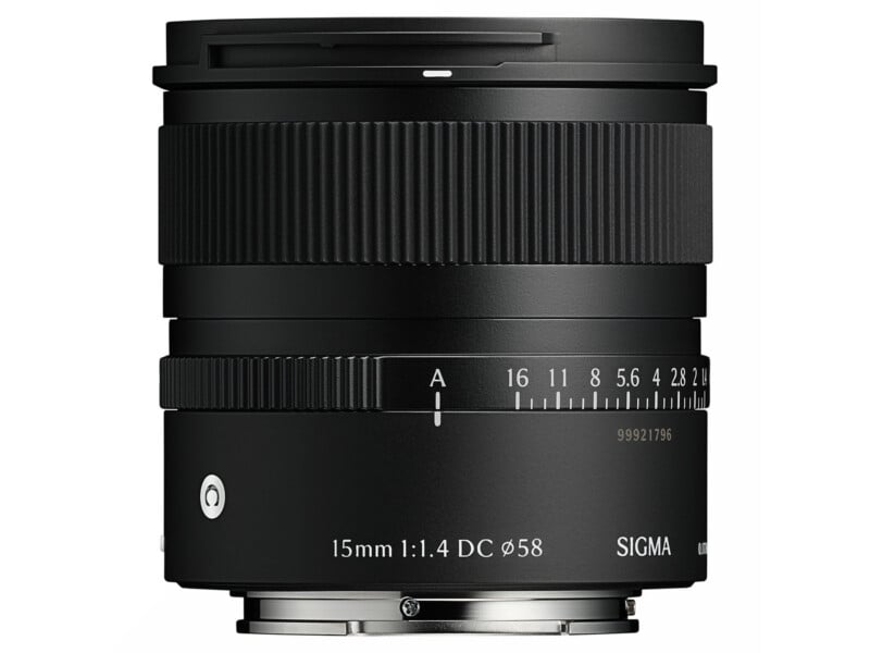 A black Sigma camera lens with a focal length of 15mm and aperture of f/1.4, featuring textured focus and aperture rings, white markings, and a metal mount at the base.