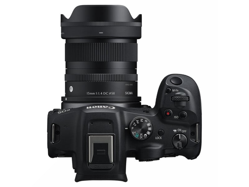 Top view of a Canon EOS camera with a Sigma 16mm f/1.4 DC DN lens attached, showing the mode dial, buttons, and lens details clearly against a white background.