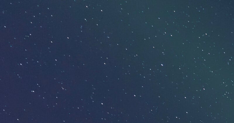 A night sky filled with many small, bright stars scattered across a deep blue and black background.