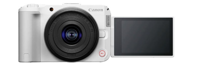 Una cámara digital Canon blanca con la lente mirando hacia adelante y una pantalla LCD abatible que se extiende hacia la derecha y muestra una pantalla en blanco.