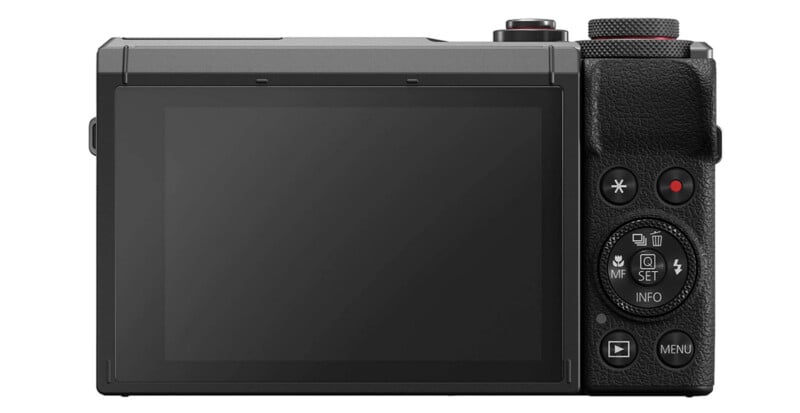 The image shows the back view of a digital camera with a large LCD screen, control buttons, and dials on the right side for navigation and camera settings.