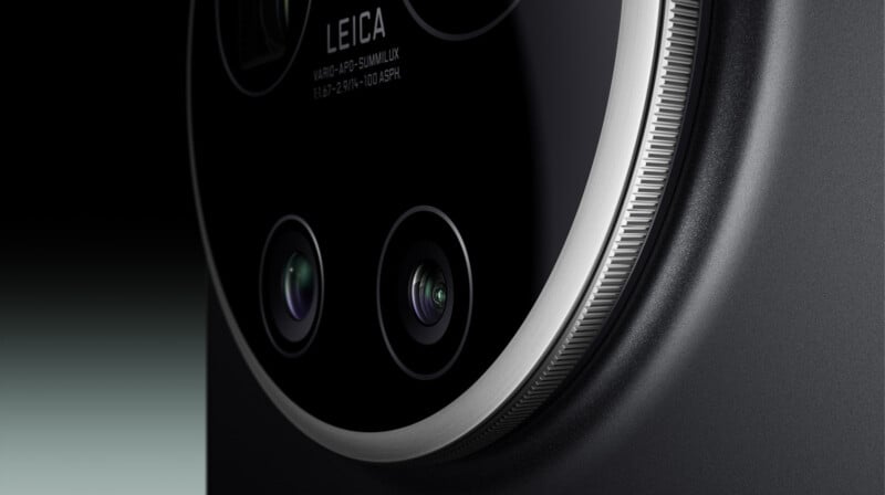 Close-up of a smartphone’s round camera module featuring two lenses and Leica branding, with a metallic rim and a sleek, dark finish.