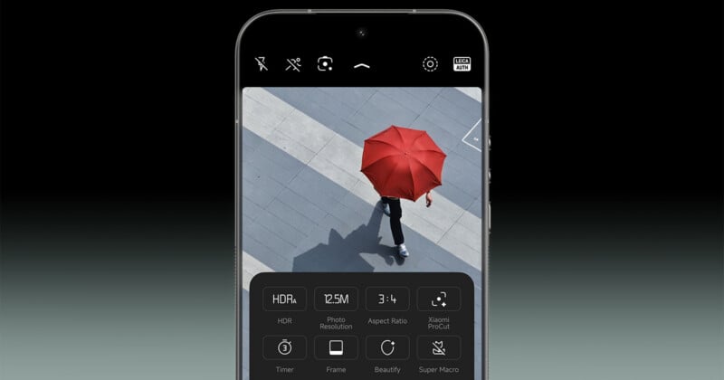 A smartphone screen displays a camera app with various settings. The screen shows an overhead photo of a person walking on a gray pavement holding a bright red umbrella.