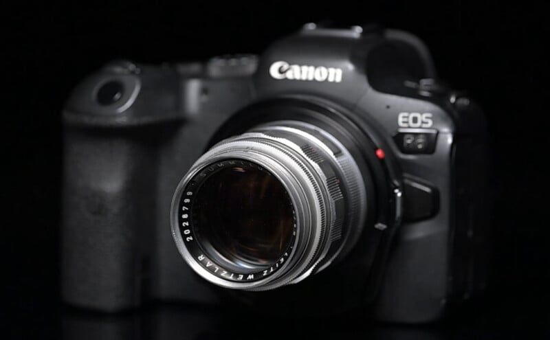 A Canon EOS camera with a vintage Helios lens attached, shown against a black background.