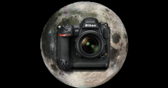 A Nikon DSLR camera is centered in front of a large, detailed image of the full moon, both set against a black background.