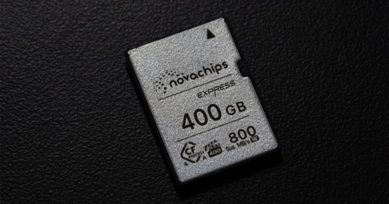 A silver Novachips Express memory card with 400GB capacity and 800 MB/s speed rating rests on a textured black surface.