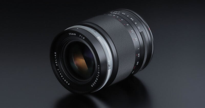 A close-up photo of a black camera lens labeled "75mm F1.8 PORTRAIT-HELIAR," with textured focus and aperture rings, set against a dark background.