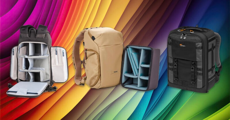 Three camera backpacks—gray, tan, and black—are shown against a vivid rainbow-colored abstract background. Each bag is open to reveal padded, customizable compartments for camera gear.