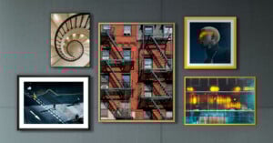 A collage of five framed photos on a gray wall, featuring a spiral staircase, a red brick building with fire escapes, a person with blond hair in dramatic lighting, a city street scene, and reflections of lights in water.