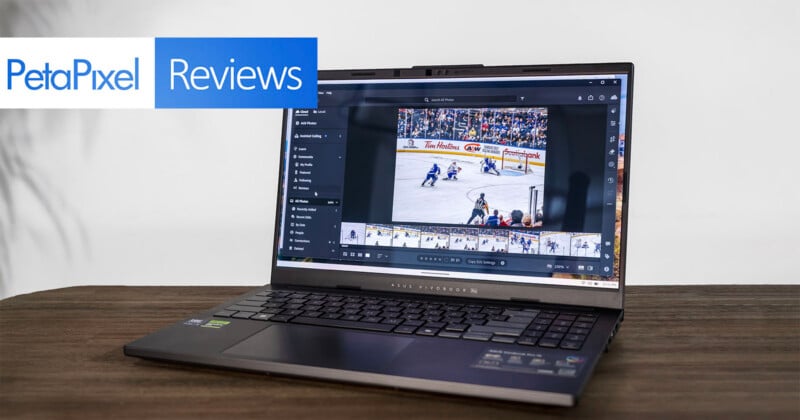 A gaming laptop on a wooden table displays a hockey game photo in editing software. The screen shows image thumbnails below. In the top left corner, there's a "PetaPixel Reviews" banner.