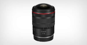 A Canon RF 7-14mm camera lens with a wide, rounded glass front element, black body, red ring near the top, and white text displaying focal length and brand, against a plain light background.