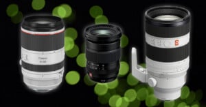 Three different camera lenses are displayed upright against a dark background with green bokeh light effects. The lenses vary in size and brand, with visible labeling and distinct design features.