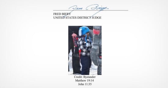 A young child in a plaid jacket and blue animal hat stands outside in the snow near a car, with an adult partially visible beside them. Text above and below the photo references a judge, Bible verses, and credits a bystander.