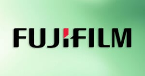 The FUJIFILM logo in bold black letters, with a red accent on the "I," is displayed against a gradient green background.