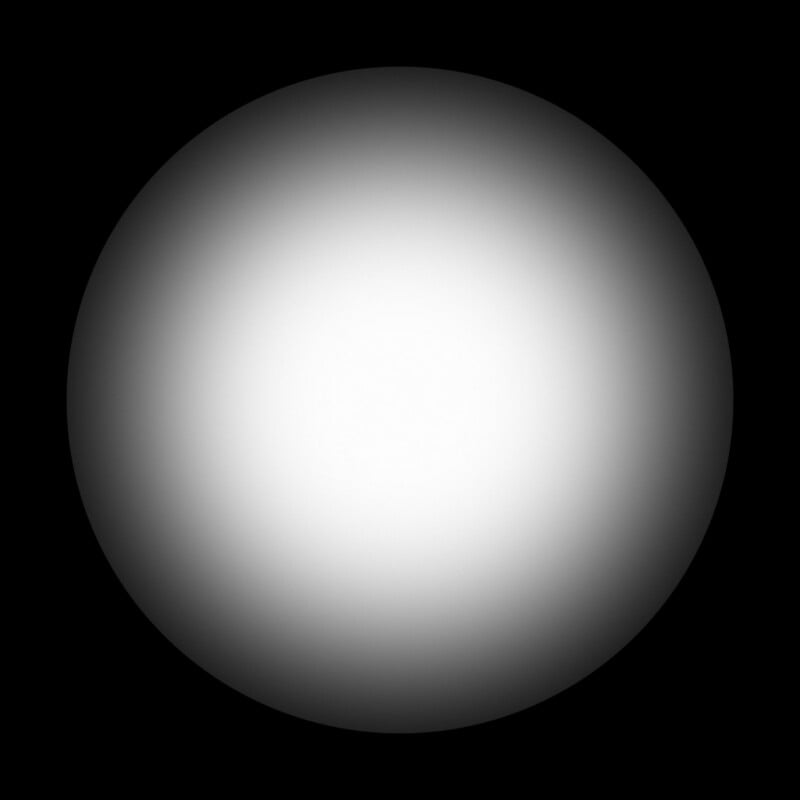 A large white circle with a soft, gradient edge fades into a black background, creating a glowing or illuminated effect.