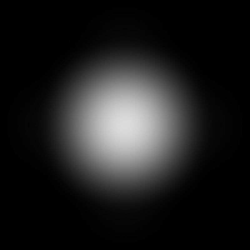 A soft, white circular glow at the center of a black background, creating a gradient effect that fades from bright in the middle to dark at the edges.
