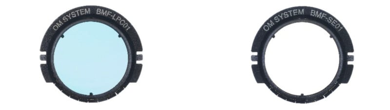 Two circular camera lens filters labeled "OM SYSTEM BMF-LPC01" (left, with a blue tint) and "OM SYSTEM BMF-SB01" (right, clear), shown against a white background.