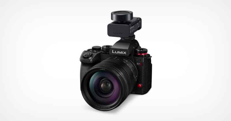 A black Panasonic LUMIX S1 camera with a large lens and an external microphone mounted on top, displayed against a plain white background.