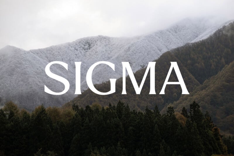 Snow-dusted mountains rise behind a dense, dark green forest. The word "SIGMA" in large, white capital letters is centered over the landscape. Mist and clouds add a moody atmosphere.