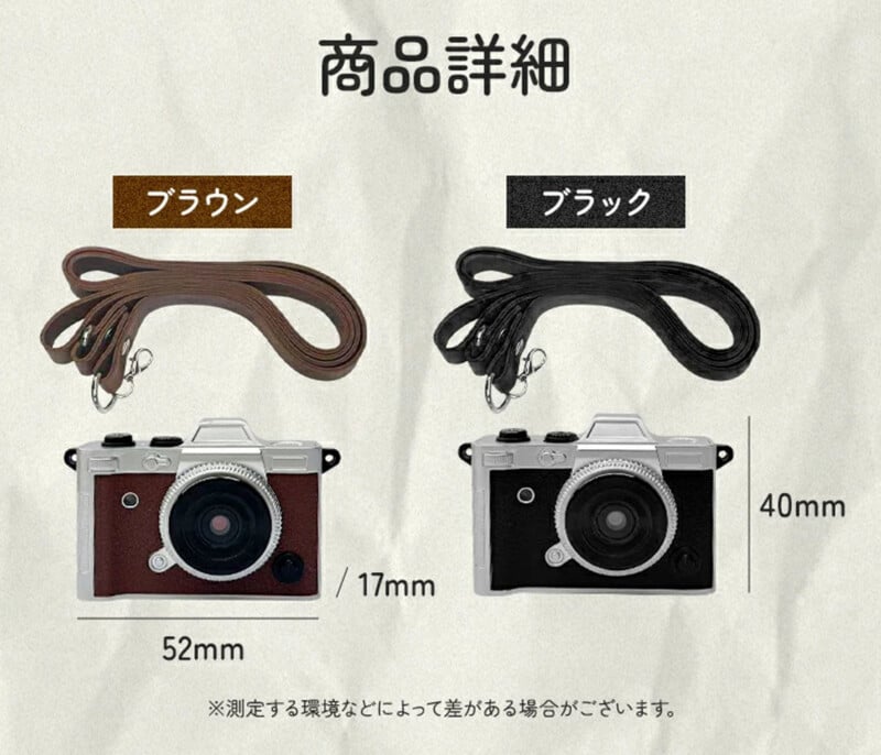 Two small camera-shaped keychains with straps are shown. One is brown with a brown strap, and the other is black with a black strap. Dimensions are labeled as 52mm wide, 17mm deep, and 40mm tall. Japanese text is present.