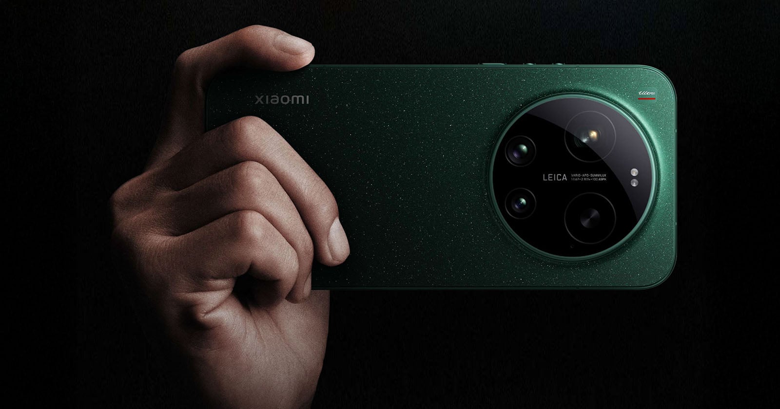A hand holds a green Xiaomi smartphone with a large round Leica camera module on the back, featuring three lenses and a textured finish.