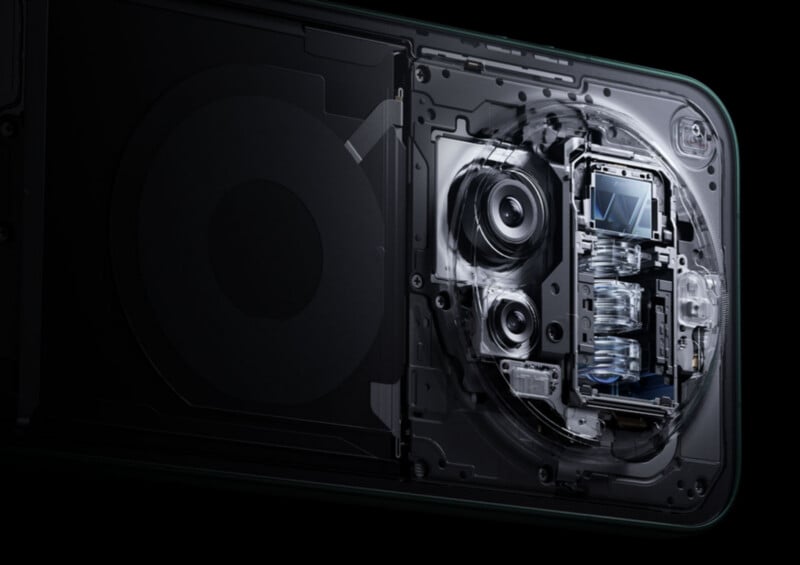 Close-up image showing the internal components of a smartphone camera system, including lenses, sensors, and mechanical parts, with a partially transparent back panel revealing the intricate design.