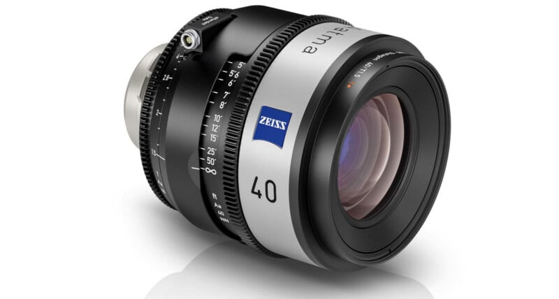 A Zeiss Supreme Prime 40mm camera lens with a silver and black body, blue Zeiss logo, and focus/aperture markings, viewed from an angle showing the glass and control rings.