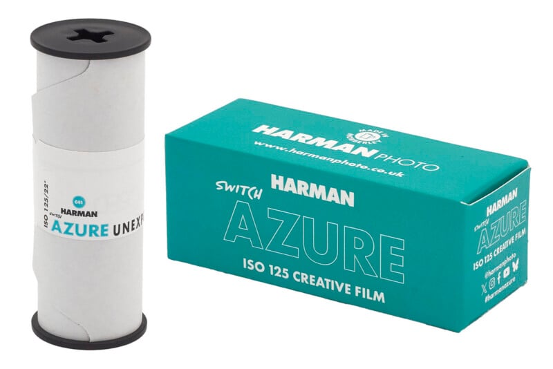 A roll of HARMAN AZURE film, wrapped in white paper, sits next to its turquoise box labeled "HARMAN PHOTO AZURE ISO 125 CREATIVE FILM" with branding and website details.