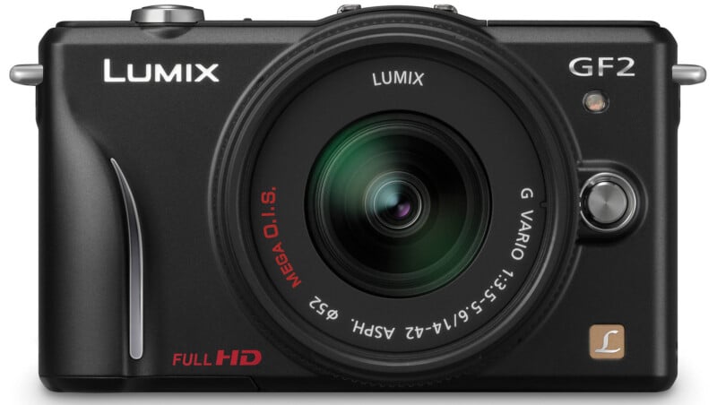 Front view of a black Lumix GF2 digital camera with a G Vario lens attached, showing lens details and camera branding, including "Full HD" printed on the body.