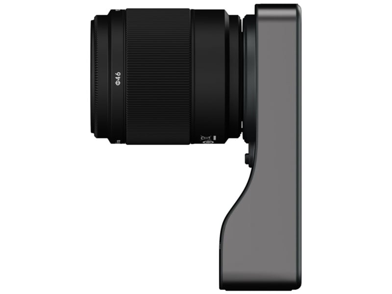 A side view of a compact digital camera with a large lens attached, shown against a plain white background. The lens features grip rings and markings, while the camera body has a minimalist, modern design.