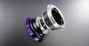 Two metallic camera lens adapters, one silver and one purple with silver, are shown separated and floating above a gray background, displaying their connection points and engraved text.