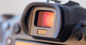 Close-up view of a camera's electronic viewfinder, showing the eyepiece and surrounding controls on the back of a digital camera.