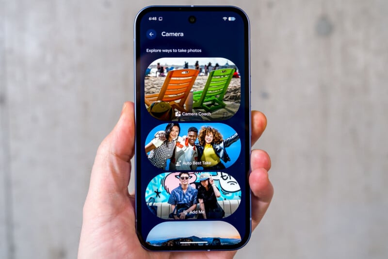 A hand holding a smartphone displaying a camera app with options: Camera Coach, Auto Best Take, and Add Me, each illustrated with colorful photos of people and beach chairs.