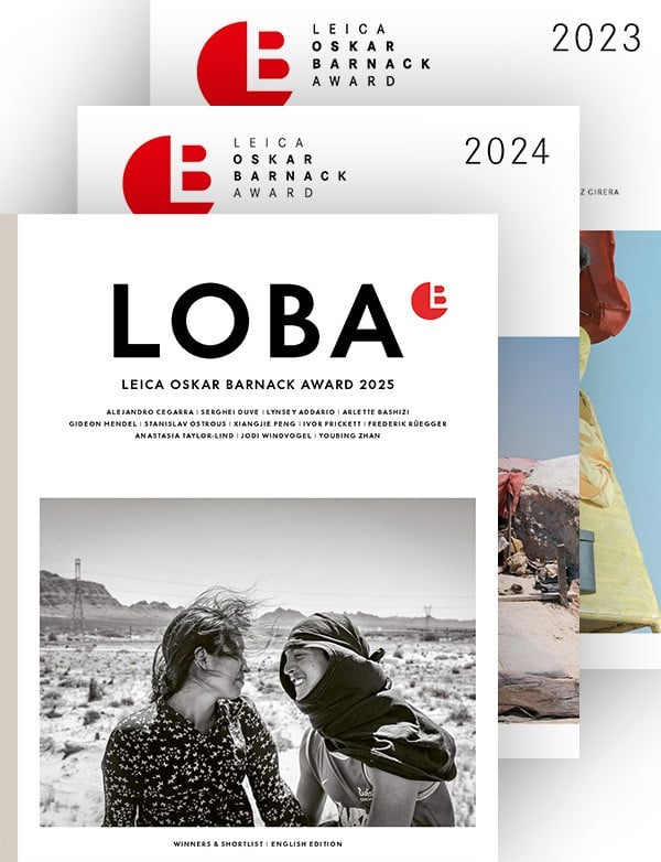 Three overlapping covers for the Leica Oskar Barnack Award (LOBA) for 2023, 2024, and 2025. The 2025 cover features two women smiling in a black-and-white photo, while the 2024 and 2023 covers are partially visible behind it.