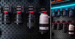 Camera lenses of various sizes and focal lengths are organized and mounted on a black perforated wall rack, with labels above indicating specifications such as 50mm, 65mm, and 100mm macro.