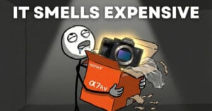 A cartoon character drools while holding a glowing Sony α7R V camera box, surrounded by torn packaging. Large text above reads, "IT SMELLS EXPENSIVE.