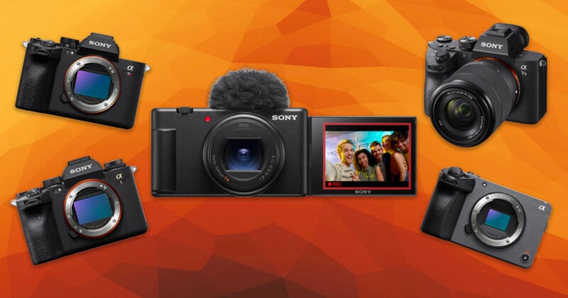 Five Sony digital cameras are displayed against an orange geometric background, with the central camera's screen showing a group selfie. The other four cameras are positioned around it, facing various angles.