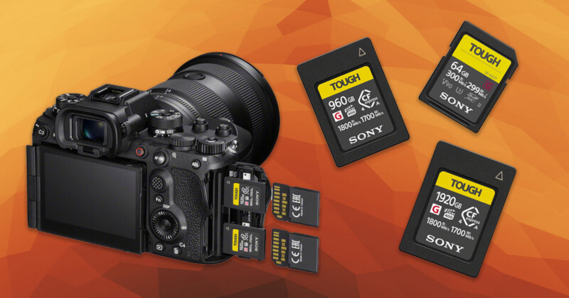A digital camera with its dual memory card slots open, each slot containing an SD card. Three additional Sony Tough SD cards are displayed beside the camera on an orange background.