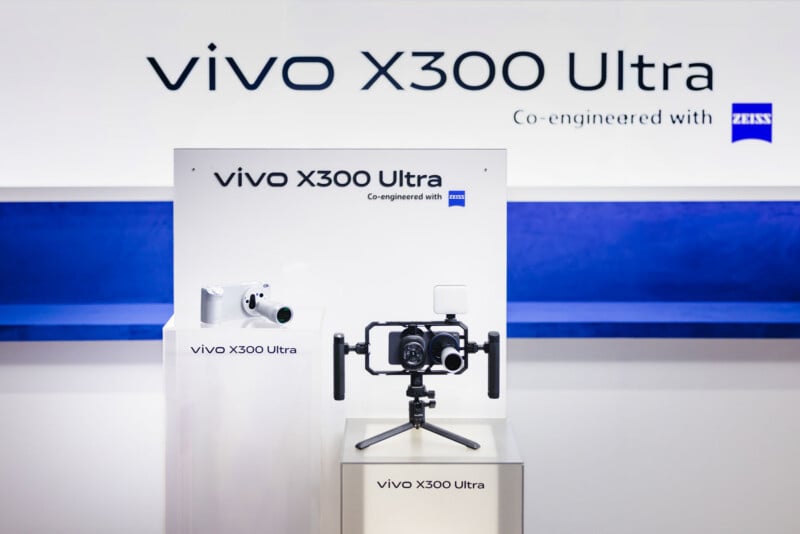 Display of the vivo X300 Ultra smartphone and camera accessories, with branded signage and "Co-engineered with ZEISS" text in the background. The setup highlights the device’s advanced camera features.