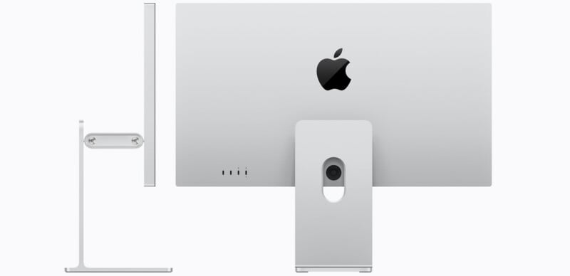 Rear and side views of a silver Apple desktop computer, showing its slim profile, stand, and the Apple logo on the back. The stand features a circular cutout for cable management.