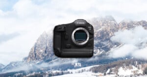 A Canon EOS R1 camera body is displayed prominently in the center, with a snowy mountain landscape and pine trees in the background under a cloudy sky.