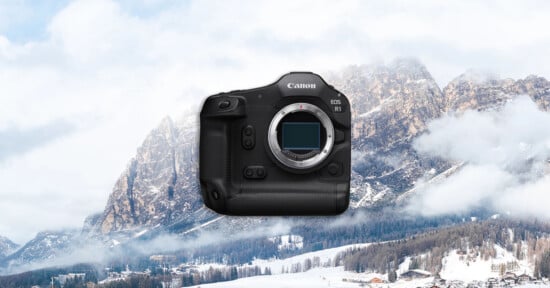 A Canon EOS R1 camera body is displayed prominently in the center, with a snowy mountain landscape and pine trees in the background under a cloudy sky.