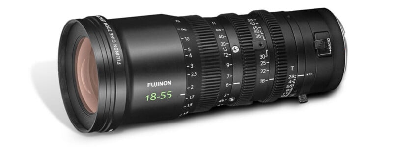 A Fujinon cine zoom lens with an 18-55mm focal length, black body, various control rings for focus, zoom, and aperture, and white markings for measurements and settings.