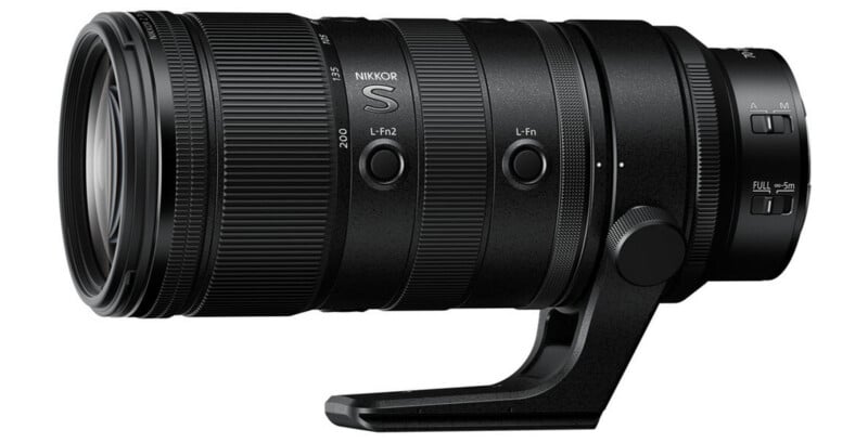 A black NIKKOR S camera lens with a tripod mount and multiple control buttons, including focus range switches and customizable buttons, is shown on a white background.