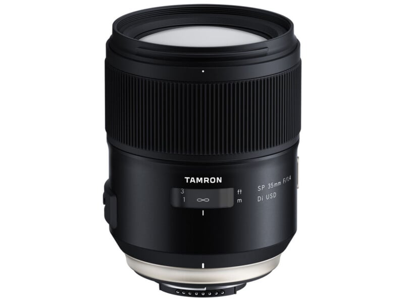 A black Tamron SP 35mm f/1.4 Di USD camera lens is shown upright on a white background, displaying its focus ring, distance scale window, and branding.