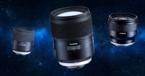 Three Tamron camera lenses are floating against a starry space background, with the largest lens centered and two smaller lenses on either side, all labeled with the Tamron brand.
