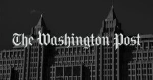 The Washington Post logo in bold, gothic-style white text is overlaid on a grayscale image of a large, multi-story building with pointed towers.